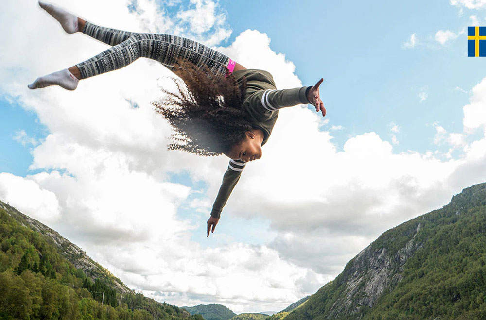 Girl jumping high in the air on high performance trampoline